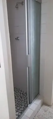 a shower with a glass door in a bathroom at Cozy studio flat in Goodwood in Goodwood