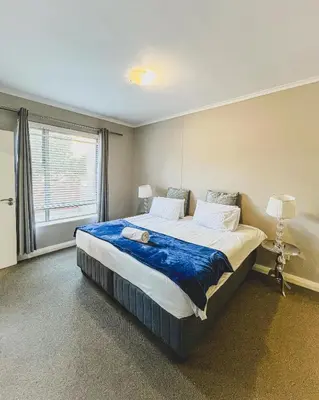 a large bed in a room with a window at Spacious 2 bedroom Apt near Canal Walk in Cape Town