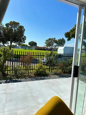 a sliding glass door with a view of a fence at Lux Sleek City Haven in Cape Town