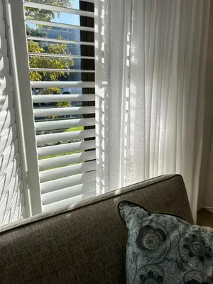 a couch sitting in front of a large window at Protea Escape - sea, sand and sun on your doorstep in Hermanus
