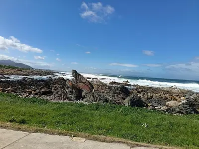 a pile of rocks on the beach near the ocean at Beautifully Sea View Escape Vermont 5 bedrooms in Hermanus