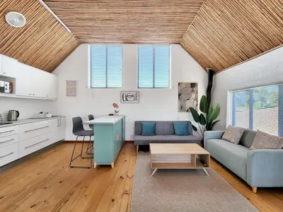 a living room with a couch and a table at The Nest at Durbanville in Cape Town