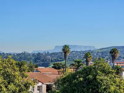 a city with palm trees and mountains in the background at The Nest at Durbanville in Cape Town