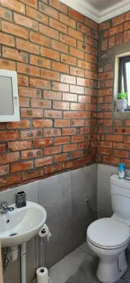 a bathroom with a white toilet and a sink at LyonsDen 1 in Worcester