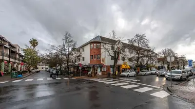 a city street with cars parked on the street at The Mustard Seed in Stellenbosch