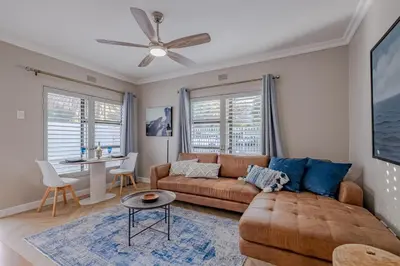 a living room with a couch and a table at Belle Apartment in Hermanus