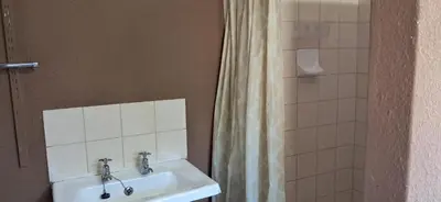 a bathroom with a sink and a shower at Clay Stone Cottage in Goodwood