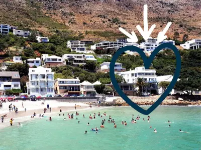 a group of people on a beach with a heart in the water at Penthouse on the beach, Jacuzzi with 3 bedrooms in Cape Town