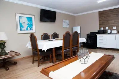 a dining room with a table and chairs at 20 On Percy Unit 3 in Parkwood