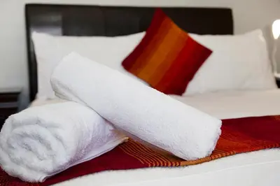 a pile of towels on top of a bed at 20 On Percy Unit 3 in Parkwood