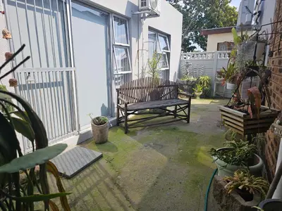 a patio with a bench and some plants at Evert's Home in Bellville