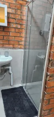a bathroom with a glass shower and a sink at LyonsDen 2 in Worcester