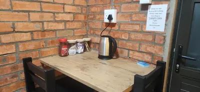 a wooden table with condiments on top of a brick wall at LyonsDen 2 in Worcester