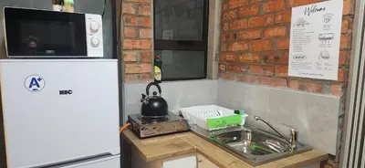 a kitchen with a sink and a refrigerator at LyonsDen 2 in Worcester