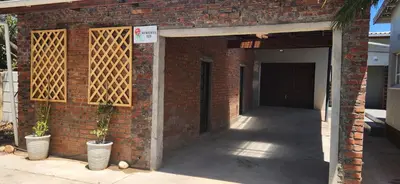 a brick building with a door and two potted plants at LyonsDen 2 in Worcester