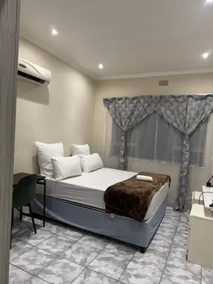 a bedroom with a large bed with a window at Ewanges holiday home in Windsor Park