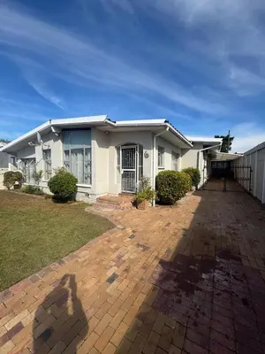a white house with a driveway in front of it at Ewanges holiday home in Windsor Park