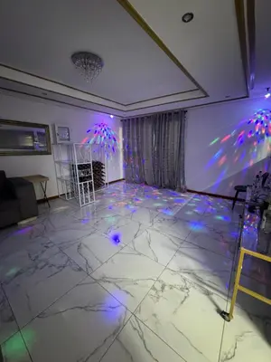 a room with a dance floor with purple and blue lights at Ewanges holiday home in Windsor Park