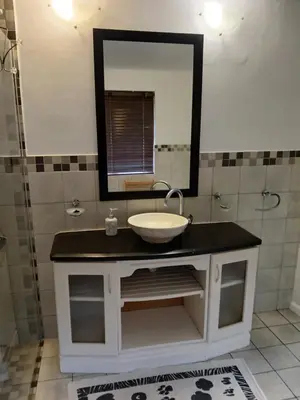 a bathroom with a sink and a mirror at Rusticana A in Cape Town