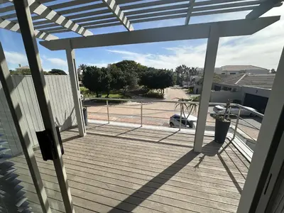 a deck with a view of a parking lot at Sunset Links Golf Estate home, walk to Beach in Cape Town