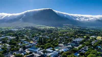 an aerial view of a city with a mountain in the background at Huguenot Franschhoek in Franschhoek