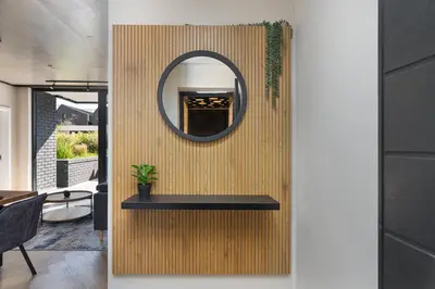 a mirror on a wall with a table in a room at Bridgewater One 309 in Cape Town