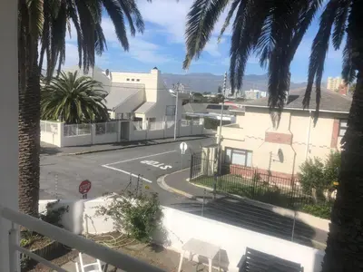 a view from a balcony of a street with a stop sign at Palmsbeach 5 in Strand