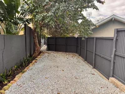 a driveway with a fence in front of a house at Dublin - 2 Bedroom Apartment in Blomtuin