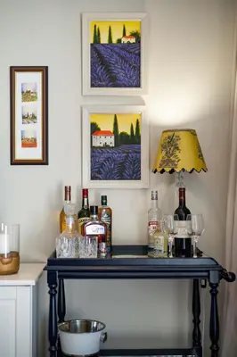 a table with a lamp and bottles of alcohol on it at The Pearl in the Winelands in Paarl