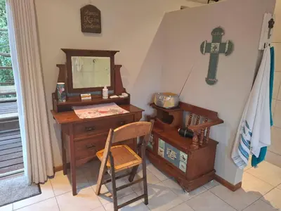 a room with a desk and a cross on the wall at Apple Pie Self-catering in Hermanus