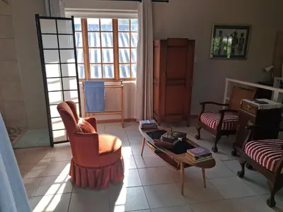 a living room with two chairs and a coffee table at Apple Pie Self-catering in Hermanus