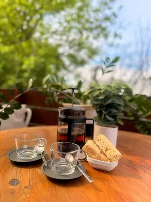 a table with plates of bread and glasses on it at Loft Escape in Onrus with Hot Tub- 2km from beach in Hermanus