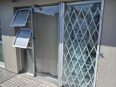 a glass door with two lights on the side of a building at 12 on lake Grassy Park in Parkwood