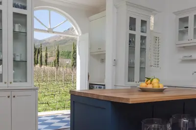 a kitchen with a counter with a bowl of fruit on it at Lily Pond House at Le Lude in Franschhoek