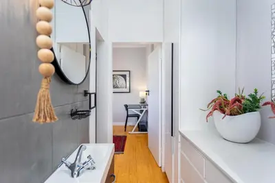 a kitchen with a sink and a mirror at Burmeister Circle by CTHA in Cape Town