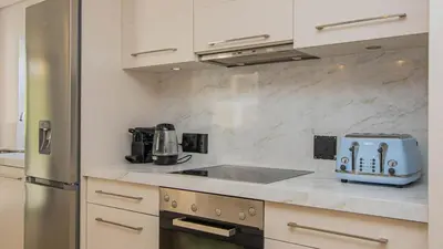 a kitchen with a sink and a toaster on a counter at Le Paradis 5 in Hermanus