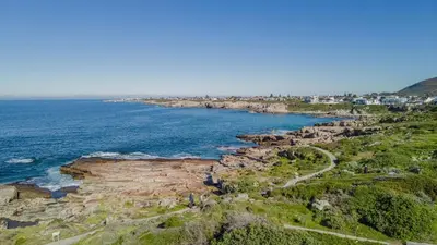 an aerial view of the ocean and a rocky coast at Le Paradis 5 in Hermanus