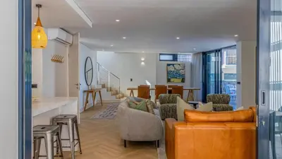 a living room with a couch and a dining room at Le Paradis 5 in Hermanus