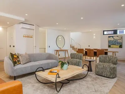 a living room with a couch and chairs and a table at Le Paradis 5 in Hermanus