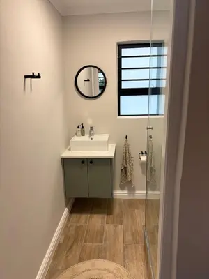 a bathroom with a sink and a mirror at Suburban Bliss in Stellenbosch