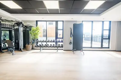 an empty room with a gym with lots of exercise equipment at Riverlands - Lux 1 bedroom Apartment with Parking in Cape Town