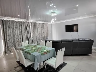 a dining room with a table and a couch at Elianta House in Cape Town
