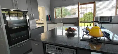 a kitchen with a yellow tea kettle on a counter at 25 on Union in Strand