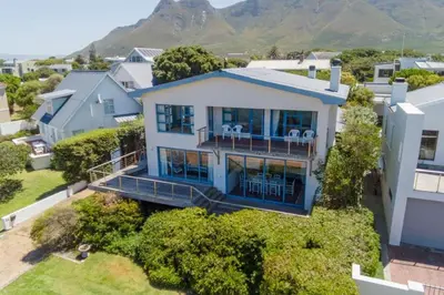 an aerial view of a house with a balcony at Pitkindie Oceanfront Escape in Hermanus