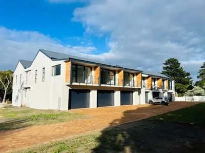 a house with a car parked in front of it at Heaven & Earth Apartment 8 in Hermanus