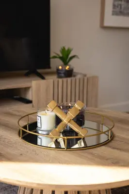a coffee table with a candle and a glass tray at Valley's Embrace Apartment 7 in Hermanus