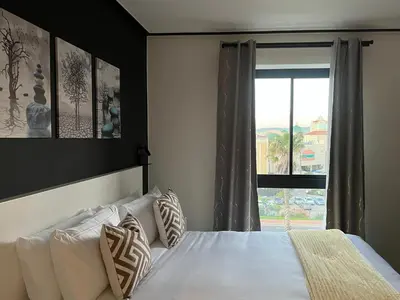a bedroom with a bed with a large window at The CoziPlace Lux in Cape Town