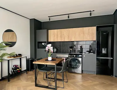 a kitchen with a table and a stove and a dishwasher at The CoziPlace Lux in Cape Town