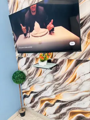 a display of a laptop on a wall with a picture at Browns villa and construction pty ltd in Cape Town