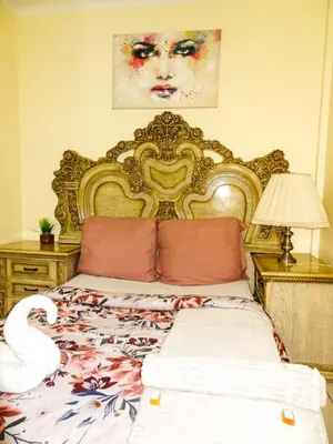 a bedroom with a large bed with a swan on it at Harmony Lodge in Elsiesrivier